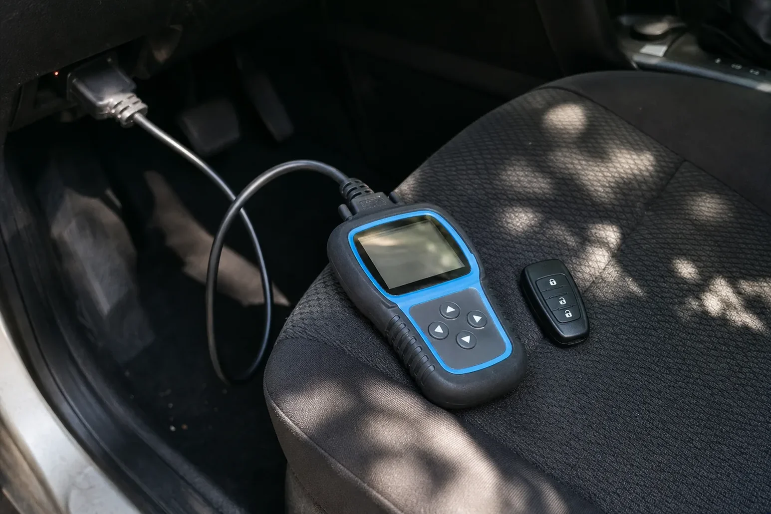 Car key programmer plugged into the OBD port, Rowlett, TX